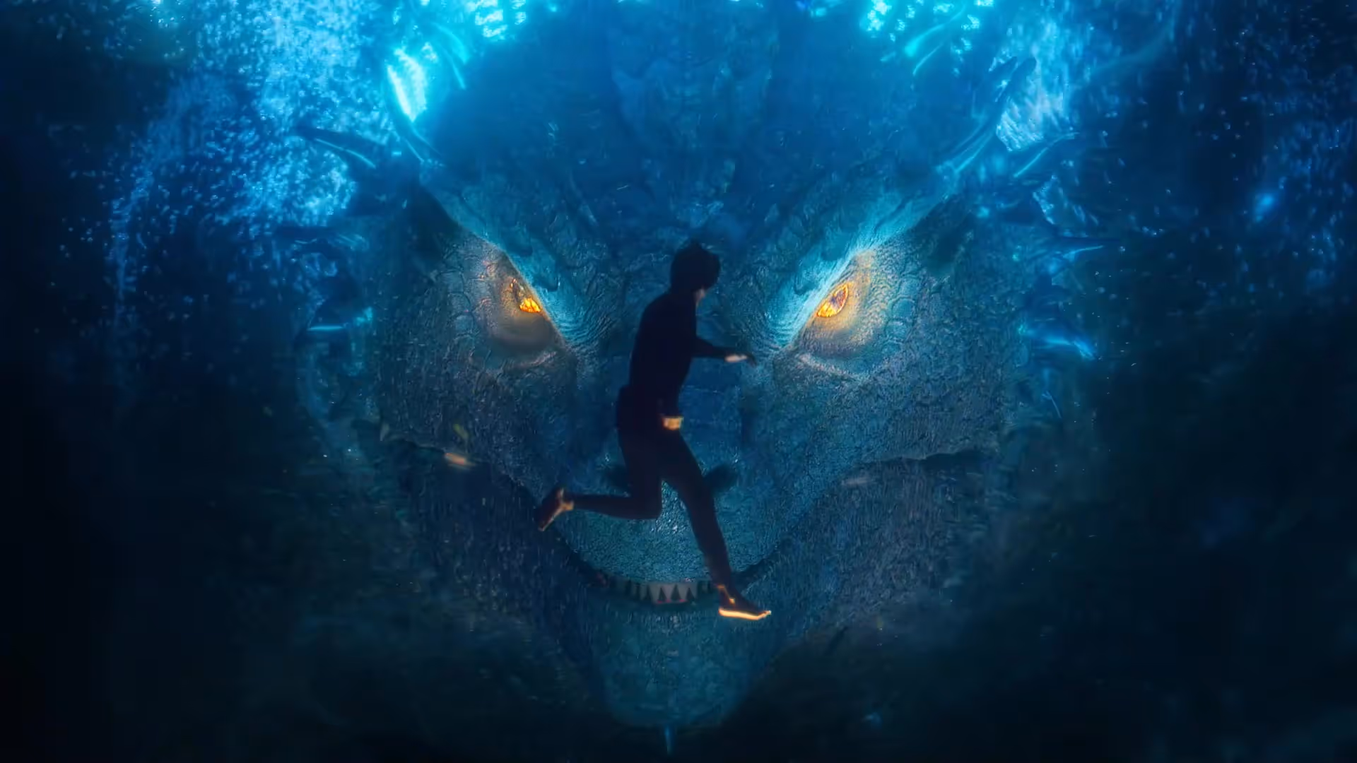 Giant face of blue dragon confronting diver