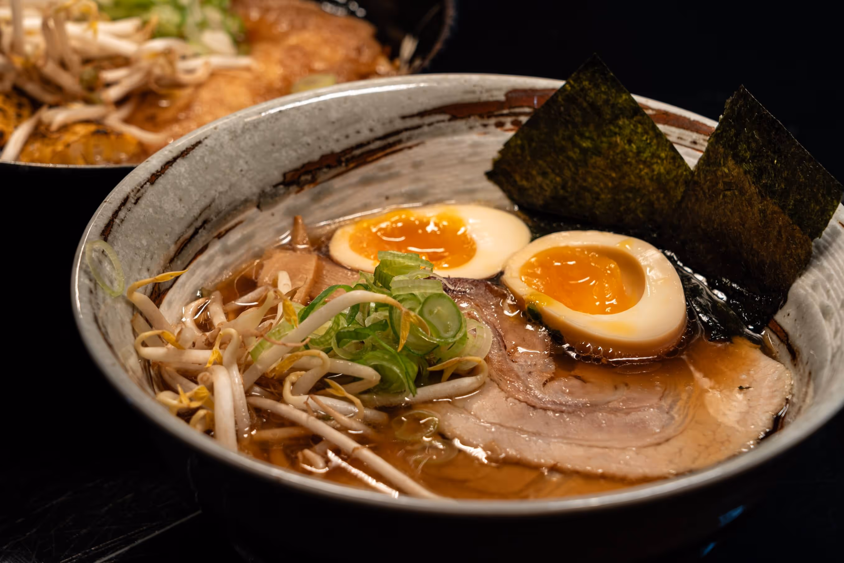 Zwei Schüsseln Chashu Ramen mit marinierten Eiern, Schweinebauch, Wakame, Soja-Sprossen und Frühlingszwiebeln in Hühnerbrühe im Nashi Restaurant am Wenigemarkt.
