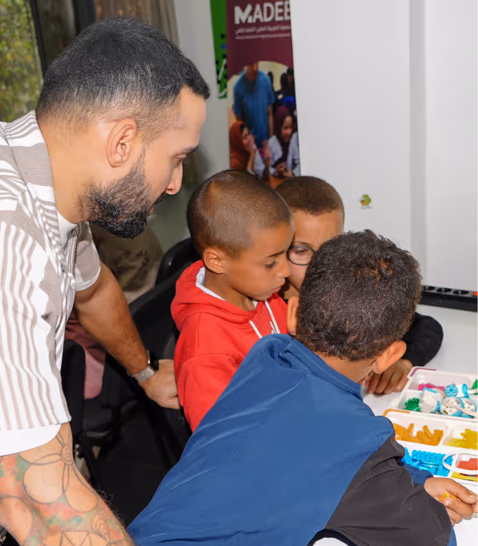 Decentralized Masters team member engaging with children at the Morocco school project