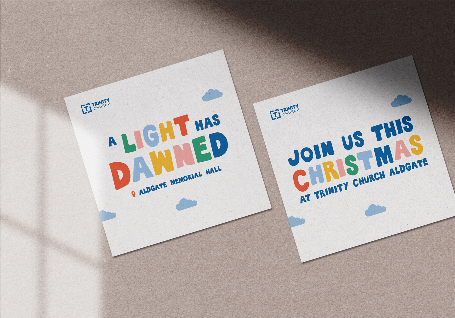 Two festive cards on a surface with colorful text about Christmas events at Trinity Church Aldgate.