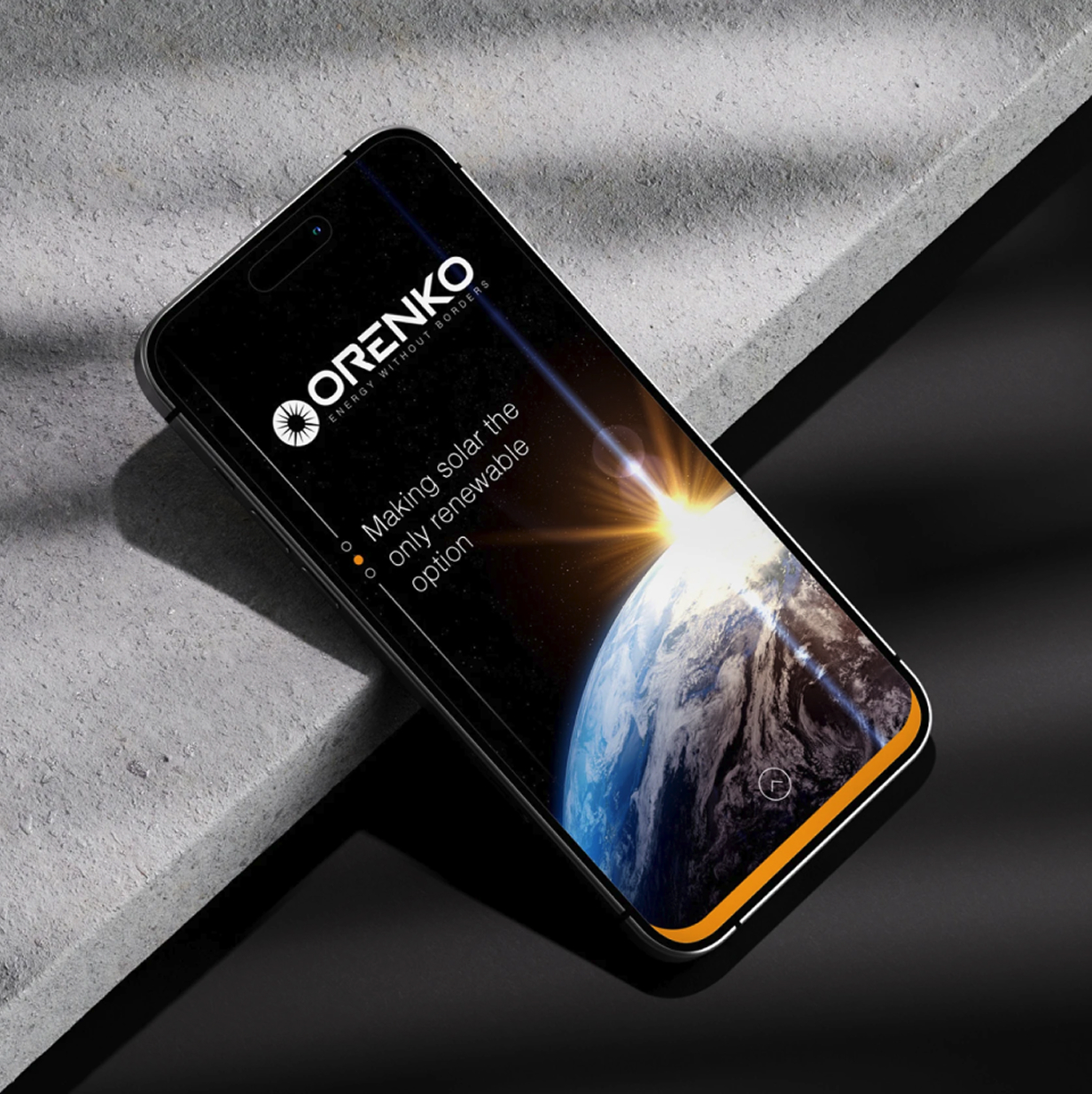 Smartphone on concrete surface displaying Orenko logo and Earth with sunrise from space.