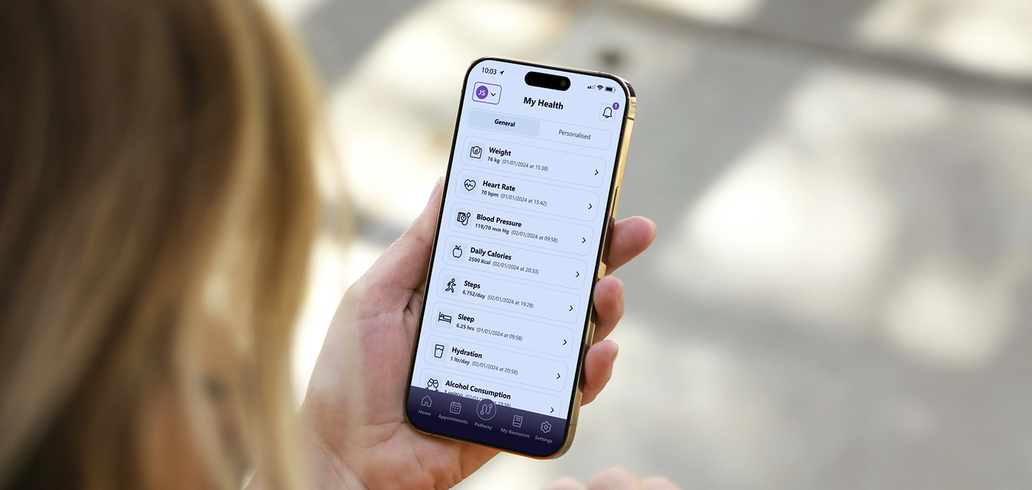 Person holding smartphone showing health app with weight, heart rate, blood pressure, calories, steps, sleep, hydration.