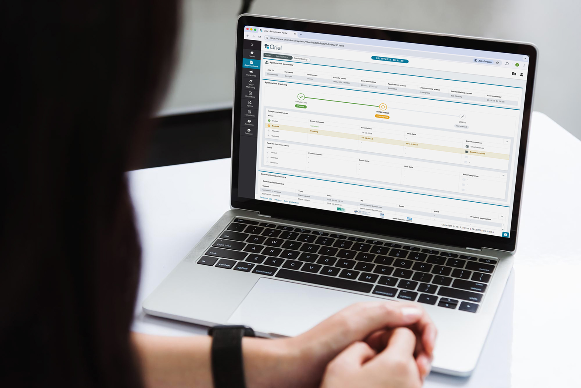 Person viewing an application tracking and recruitment portal on a laptop screen.