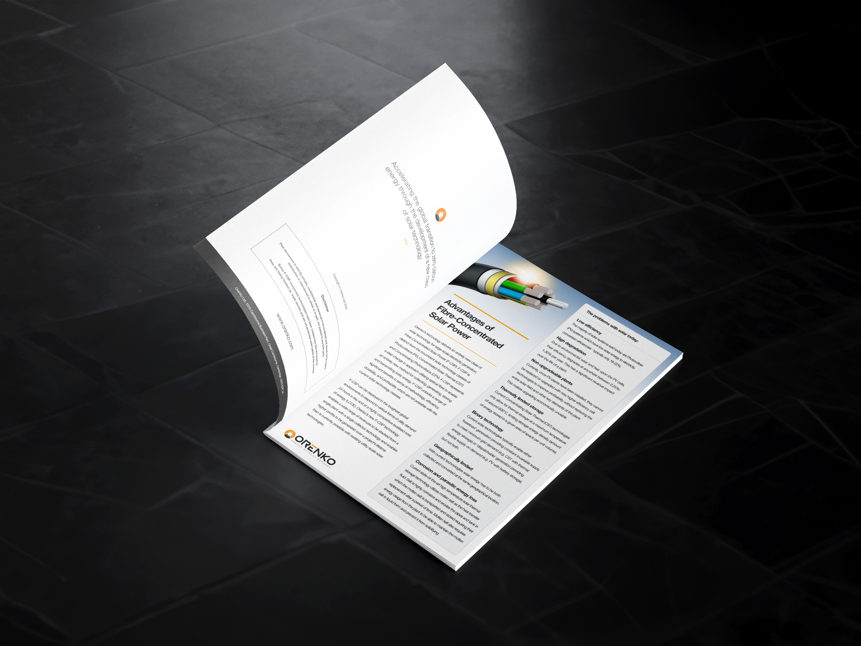 Open brochure on black surface showing advantages of fiber-concentrated solar power with diagram.