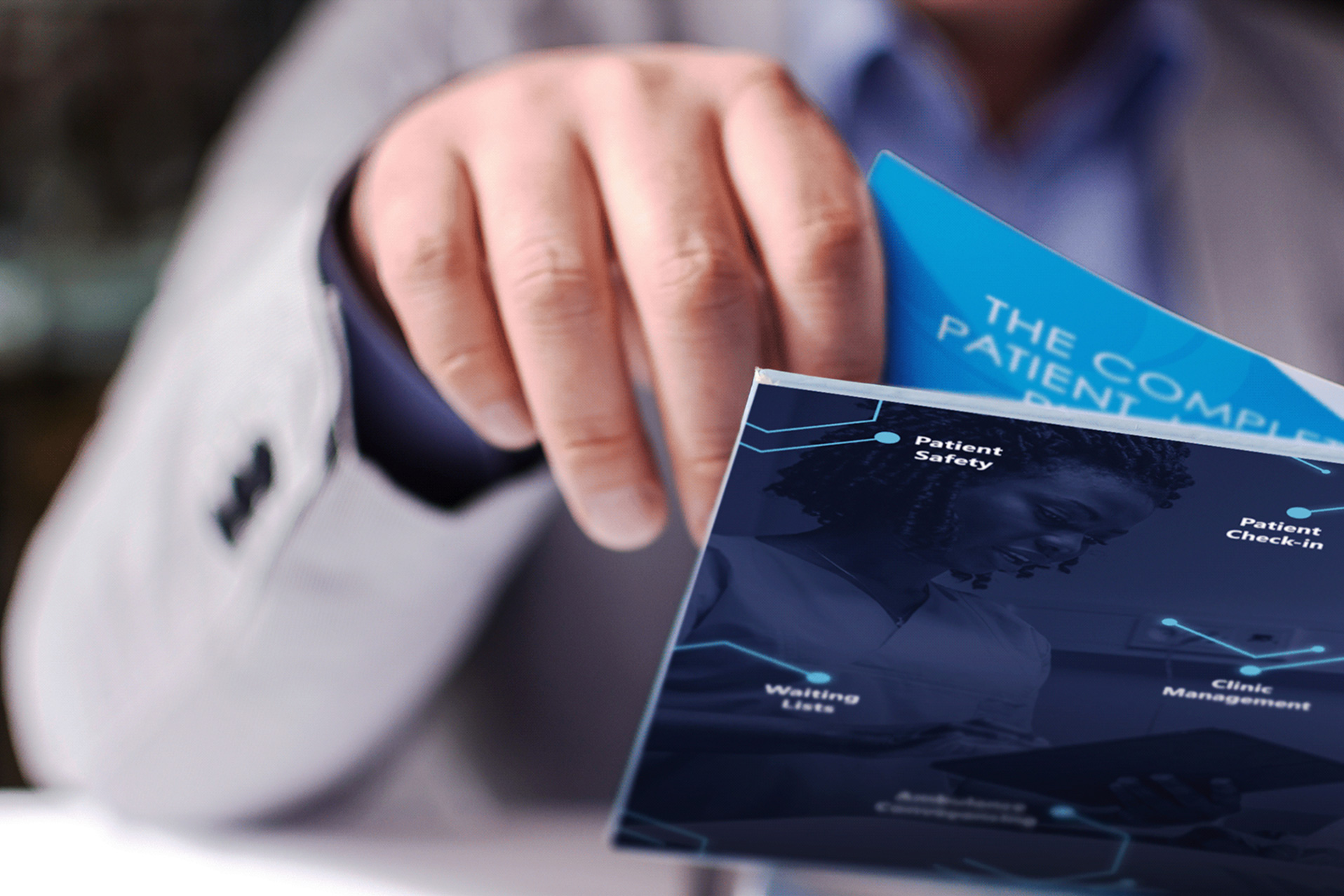 Person holding a brochure titled The Complete Patient with healthcare-related terms and image.