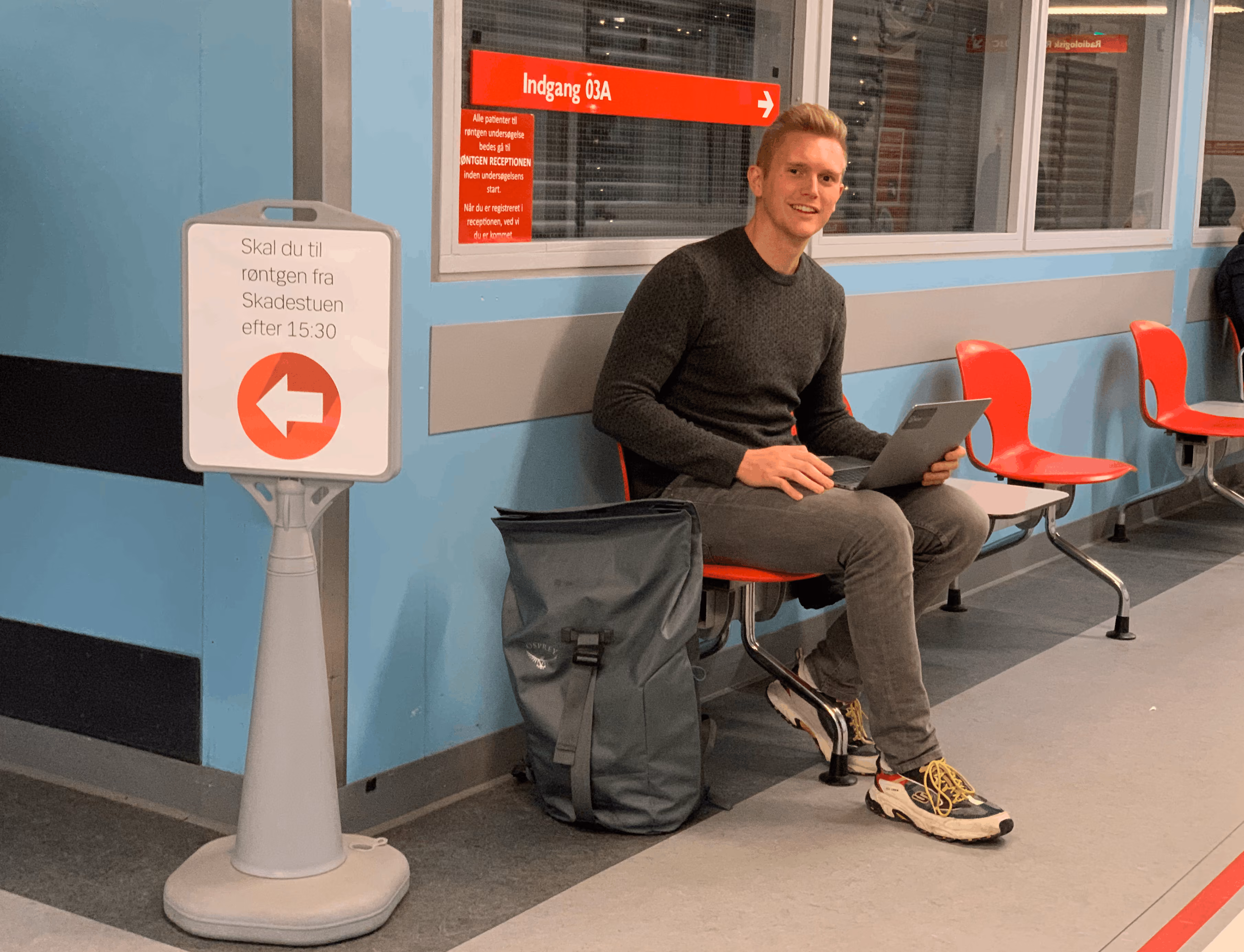 Simon Elliott Thomassen working on a laptop in a corridor at Nordsjællands Hospital during development and user testing.