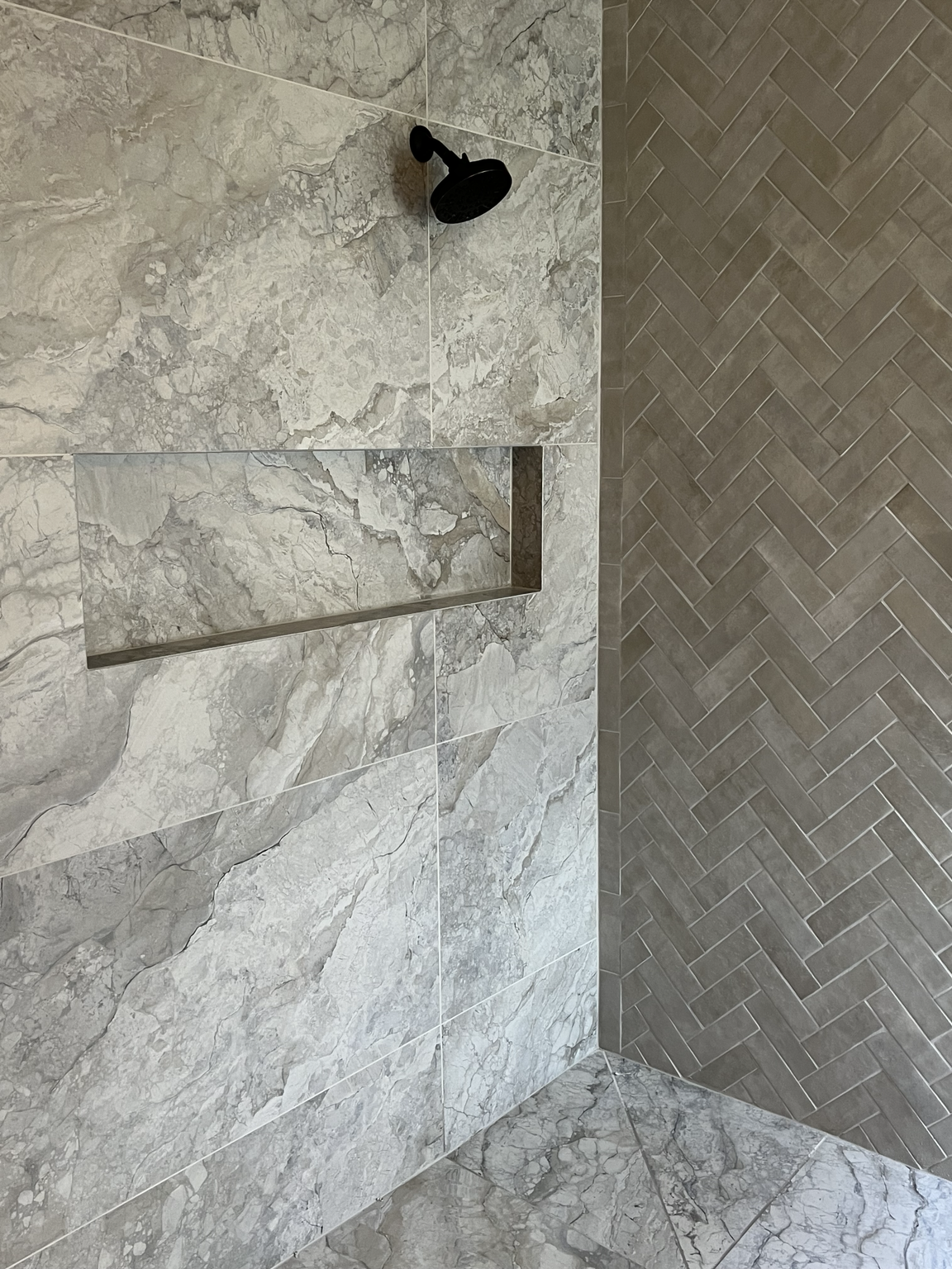 Herringbone shower with Stone FIBO wall panels