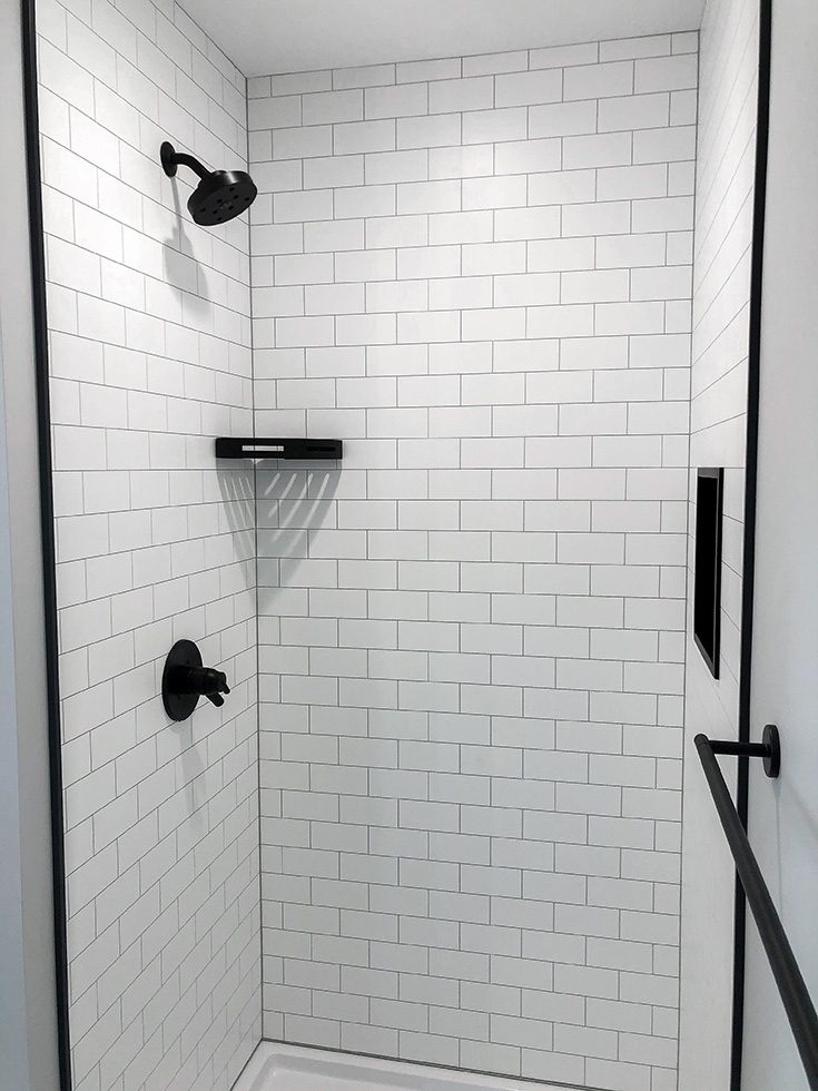 Herringbone shower with Stone FIBO wall panels