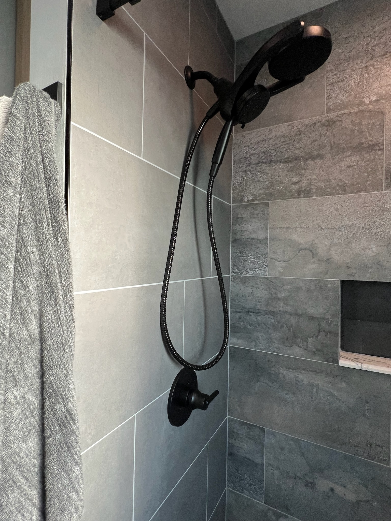 Herringbone shower with Stone FIBO wall panels