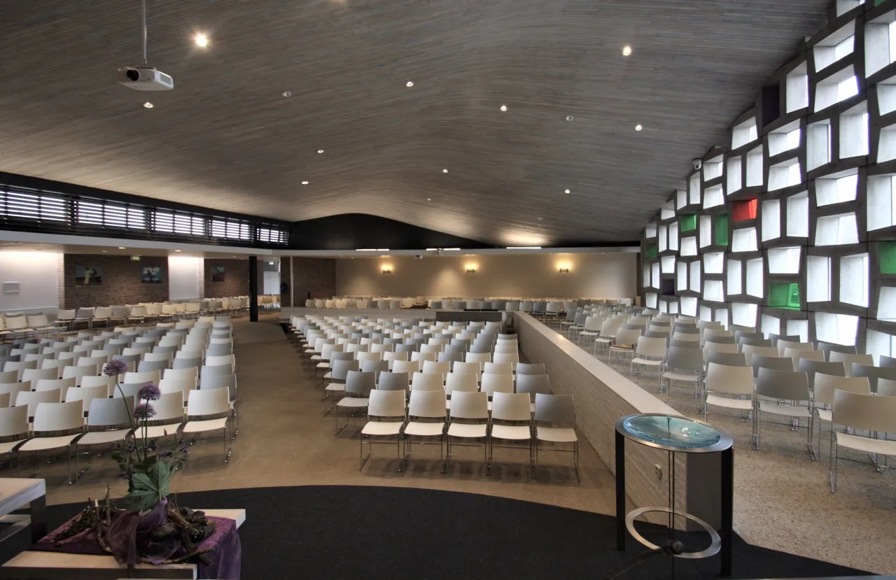 Vernieuwde kerkzaal van kerk Open Hof met achterwand en glaswand, ontwerp Agnes Compagne