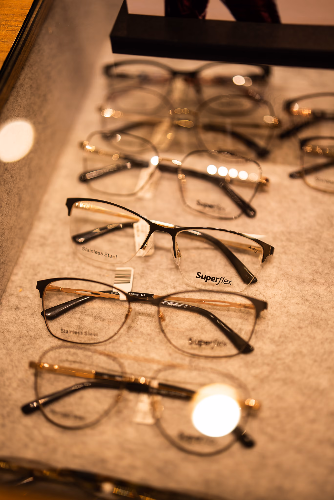 Close-up of designer eyeglass frames on display at Vision Care Woodward.