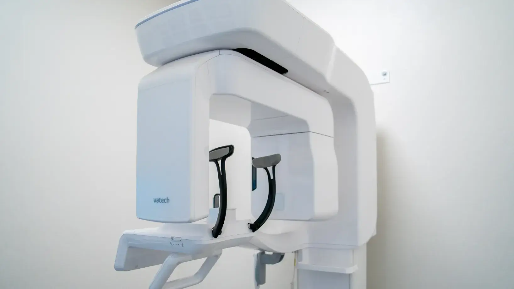 White Vatech dental panoramic X-ray machine in a clean clinical room.