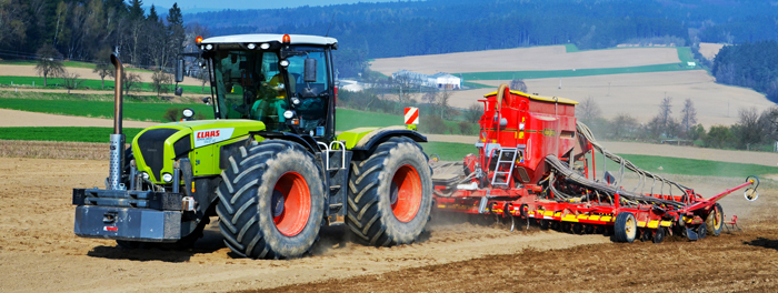 Tractor with a seed drill in a field