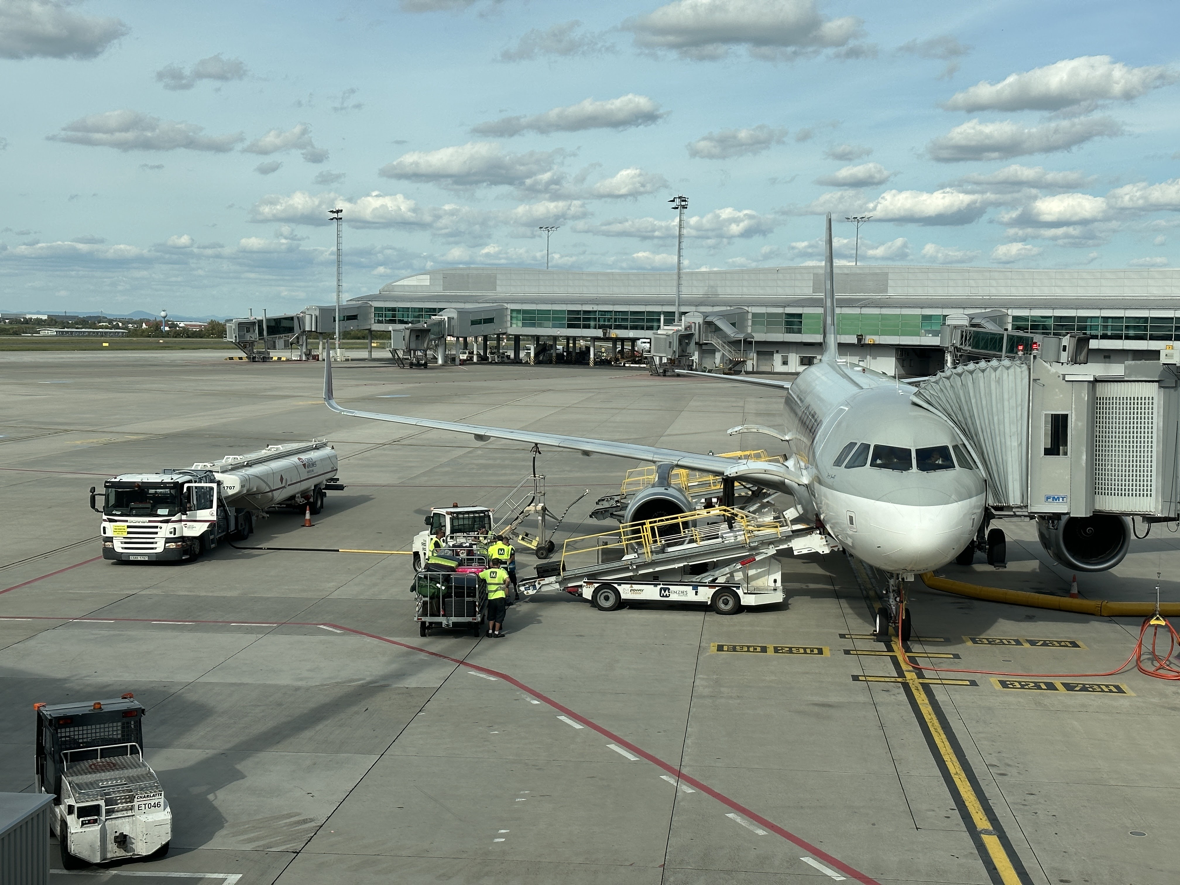 Ground handling vehicles serving an aircraft at Prague Airport