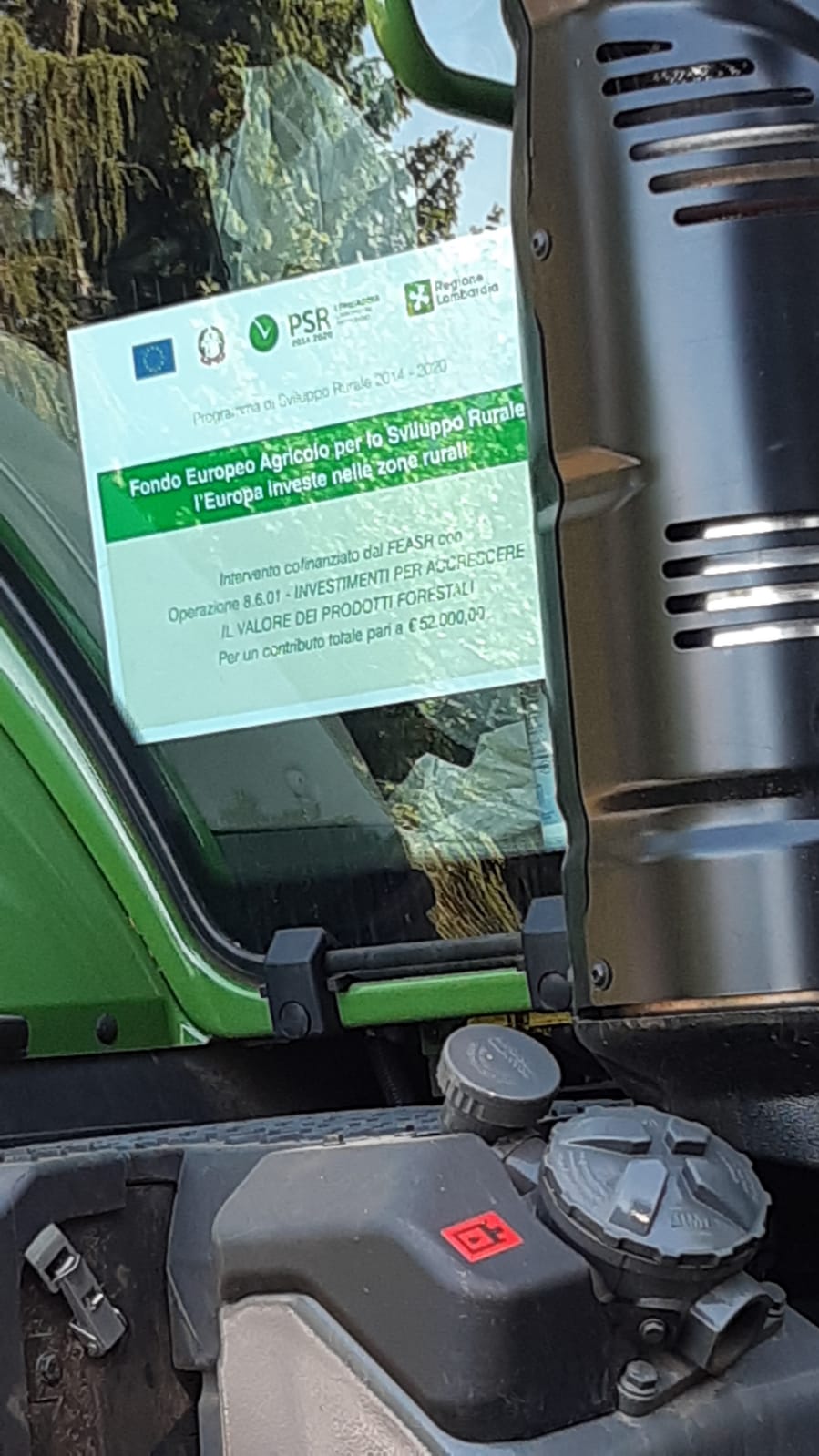 Close-up of a green vehicle showing a sticker about European Agricultural Fund for Rural Development.