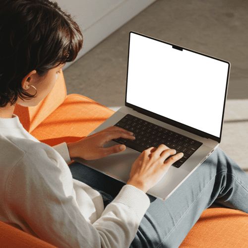 MacBook Pro Mockup with a Woman Working on Sofa