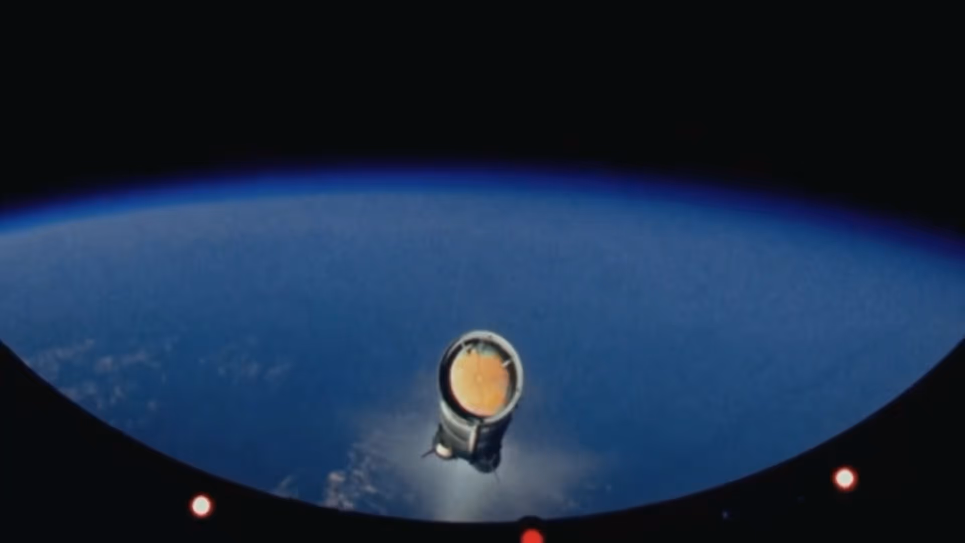 Rocket viewed from spacecraft window with Earth’s blue horizon and space in the background.