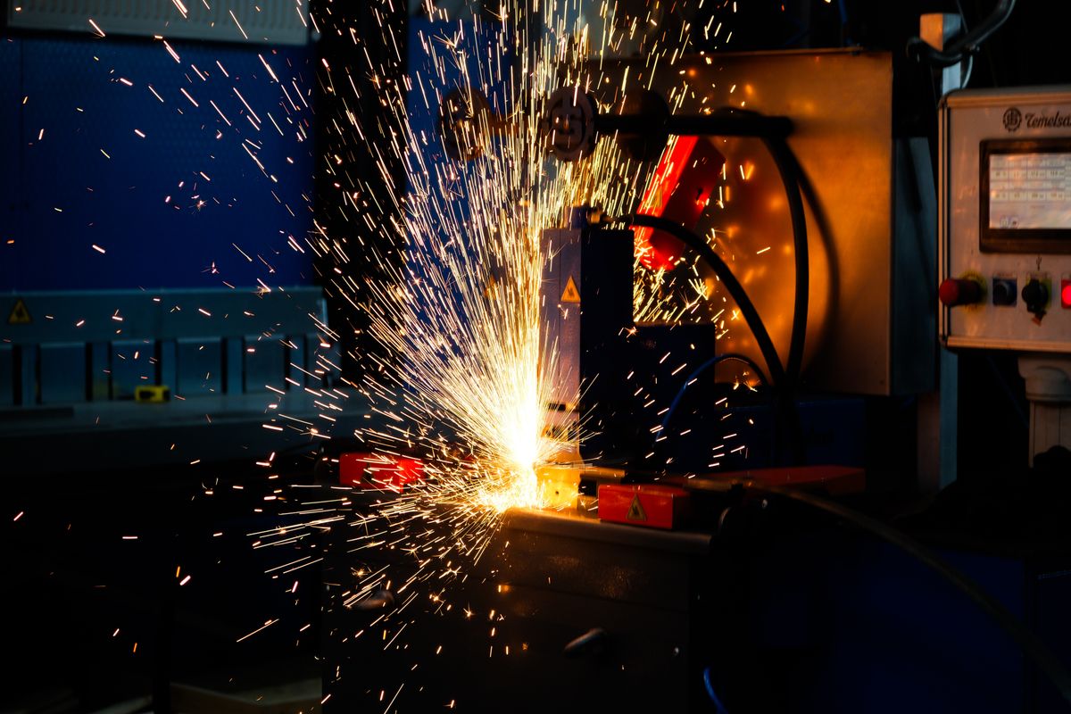 A welder cutting steel, sparks flying