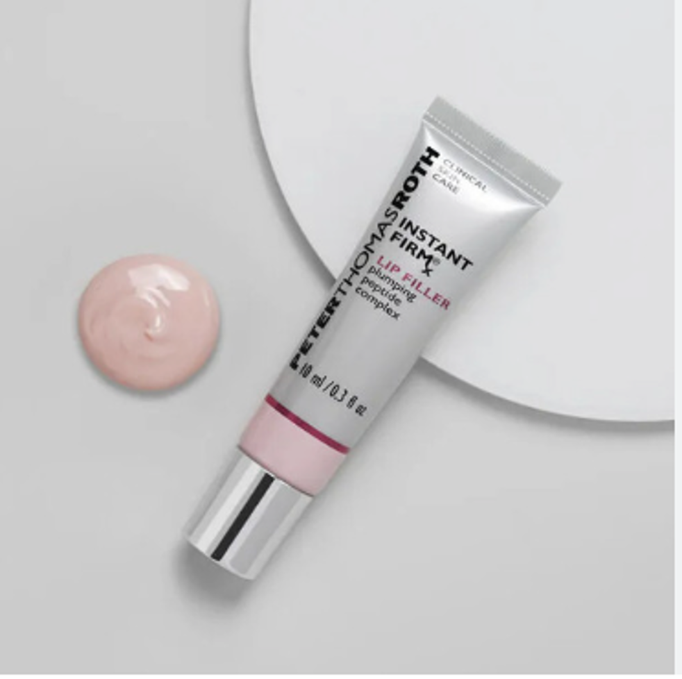 Tube of Peter Thomas Roth Instant FirmX Lip Filler cream and a dollop of pink cream beside it.
