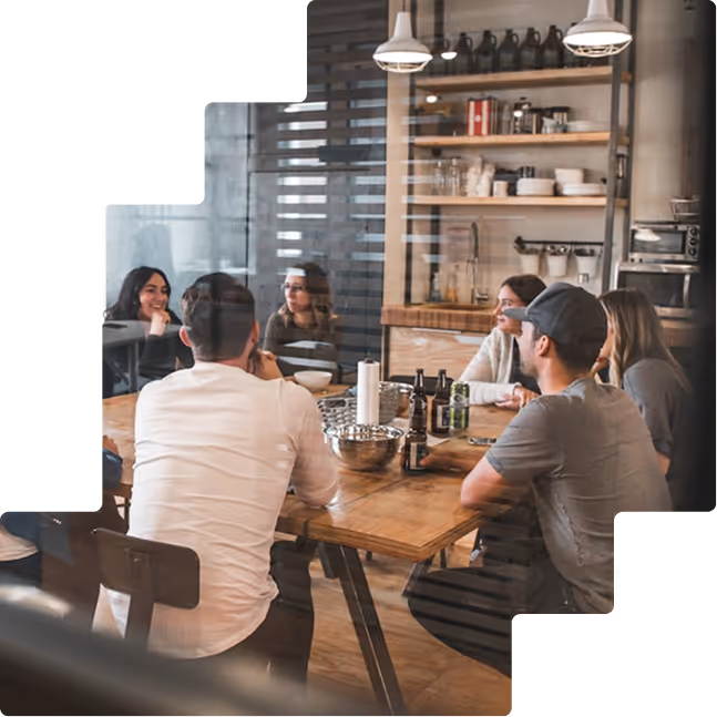 Team gathering at long wooden table together