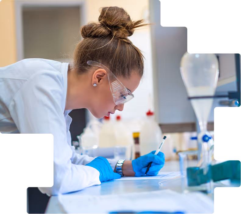 Female student researcher writing notes in lab
