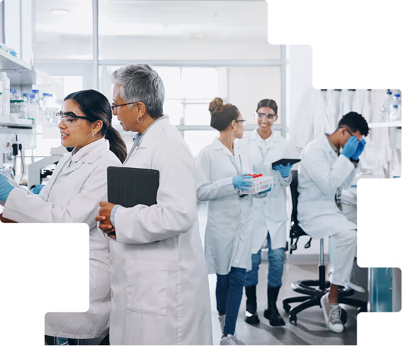 Diverse research team in white coats collaborating