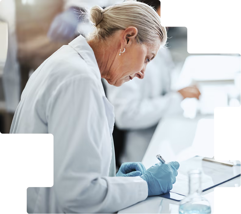 Woman writing at bench: Senior lab professional recording study observations on a clipboard
