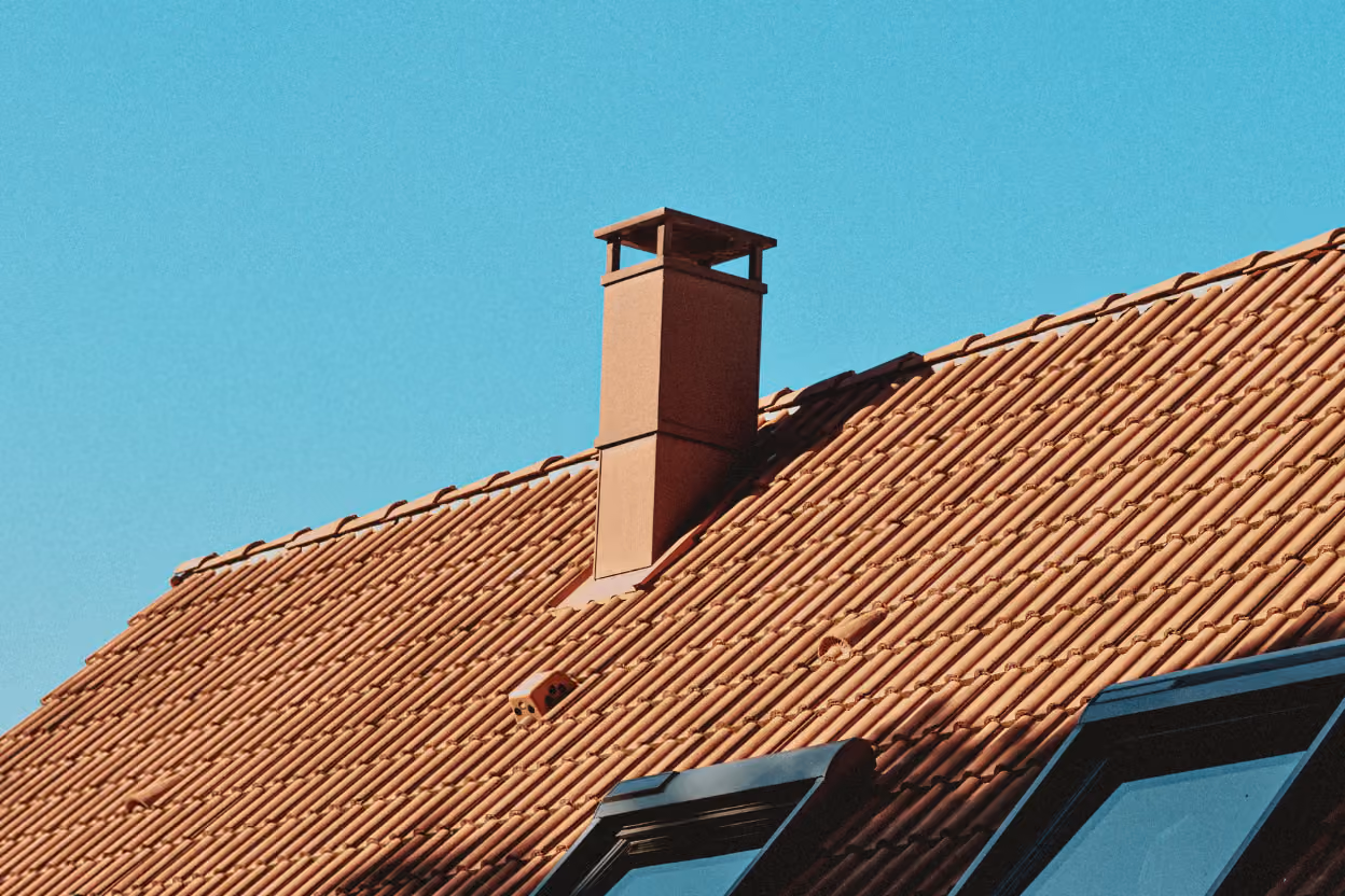Metal chimney cap on a rooftop.