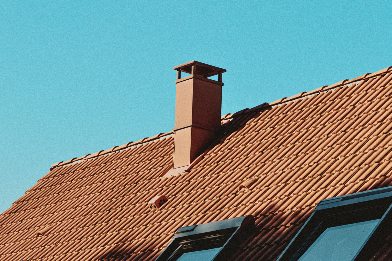 Metal chimney cap on a rooftop.