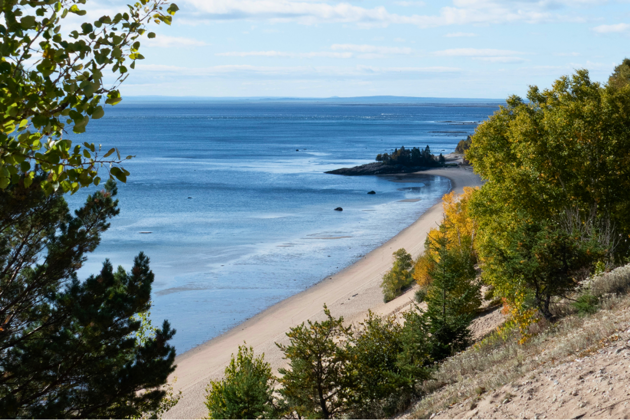 The St. Lawrence estuary shoreline and beach below the sand dunes of the Haute-Côte-Nord in autumn
