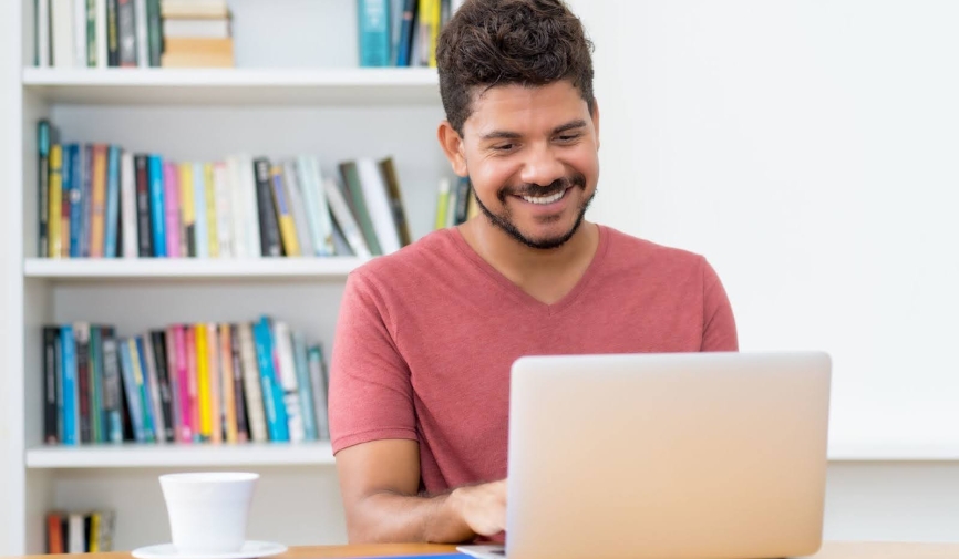 Man watching a movie on a laptop | Best Spanish-language movies of all time
