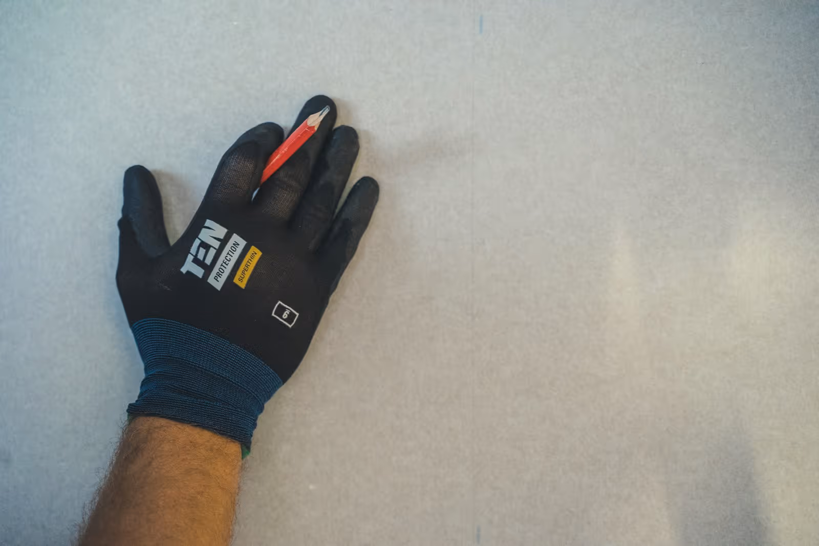 Gloved hands cutting wire during a residential electrical job in New Jersey