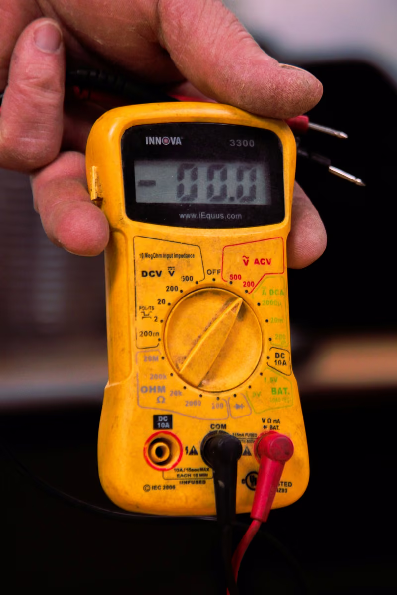 Licensed electrician inspecting an electrical panel in a New Jersey home