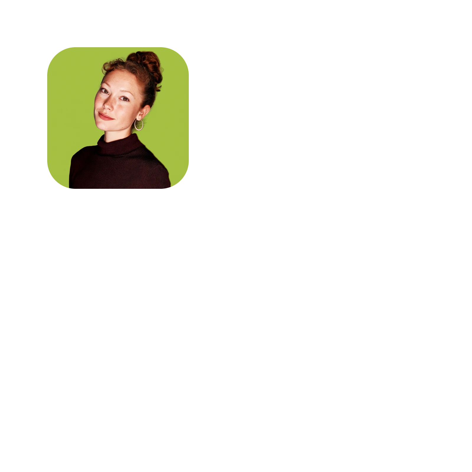 Portrait of a young woman with red hair in a bun wearing hoop earrings and a black top against a green background.