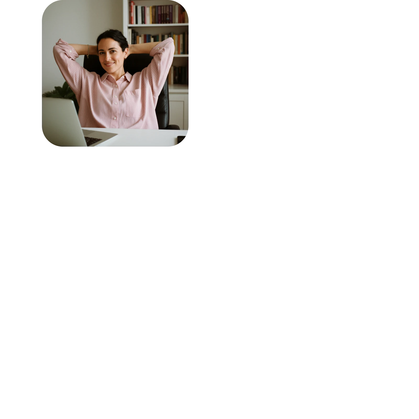 Smiling woman in a pink shirt leaning back with hands behind her head at a desk with a laptop.