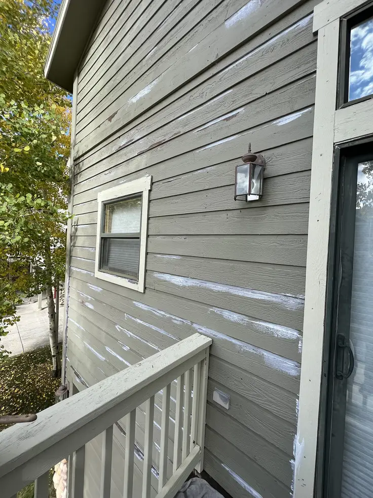Exterior painting prep work showing caulk patches and surface preparation on townhome at Blue River Run Silverthorne Colorado