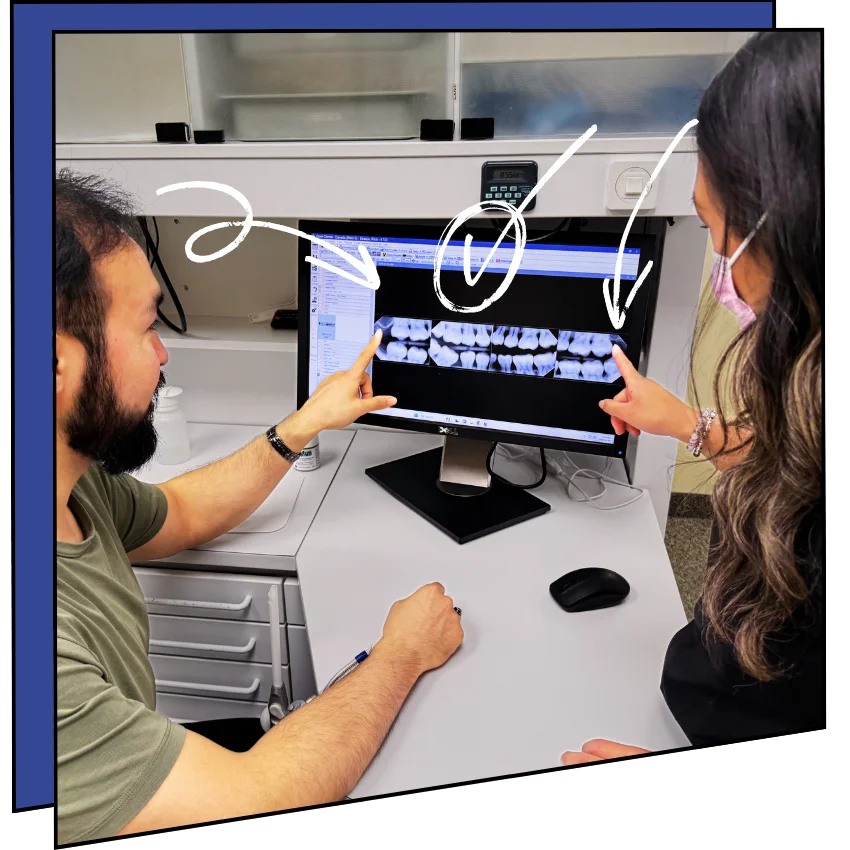 Hygienist and patient looking at x-rays.