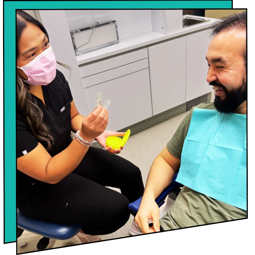Hygienist showing a patient a mouth guard.