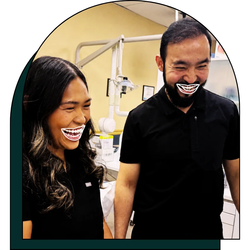 Hygienist and dentist laughing together.