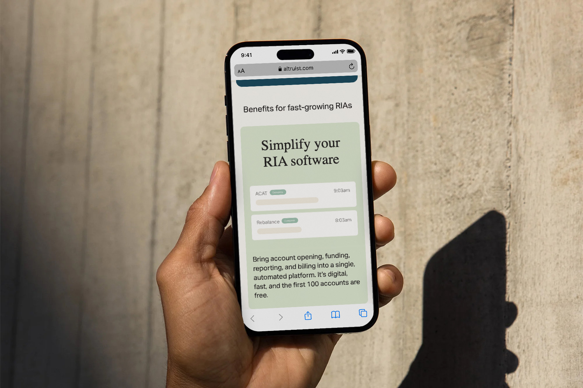 Hand holding smartphone showing a webpage about simplifying RIA software for fast-growing RIAs.