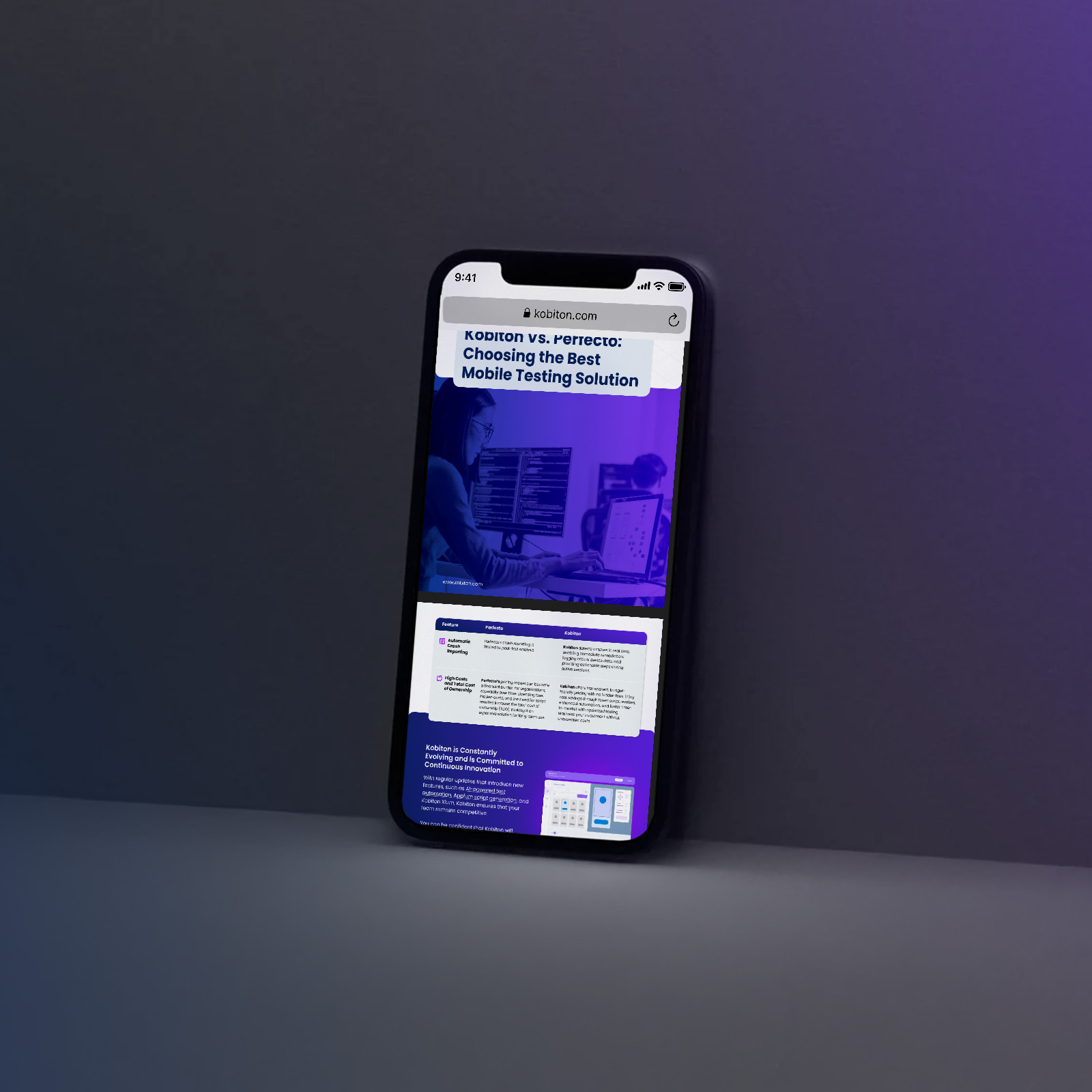 Smartphone leaning on a table displaying an article comparing Kobiton and Perfecto mobile testing solutions.