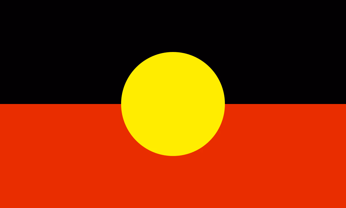 Flag with top half black, bottom half red, and a central yellow circle representing Aboriginal Australia.