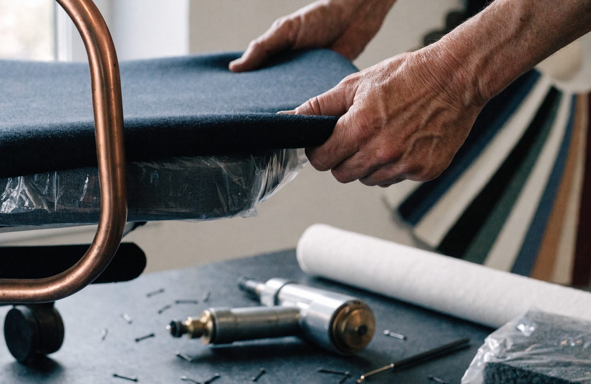 Reupholstering an office chair in the Roberts shop