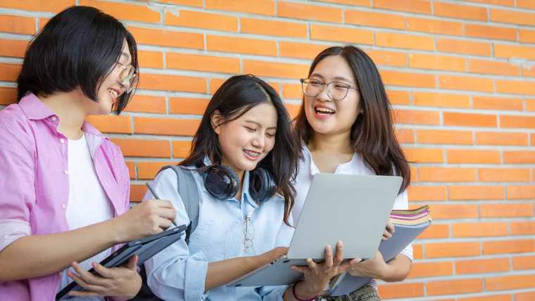 Students studying together outdoors on a university campus