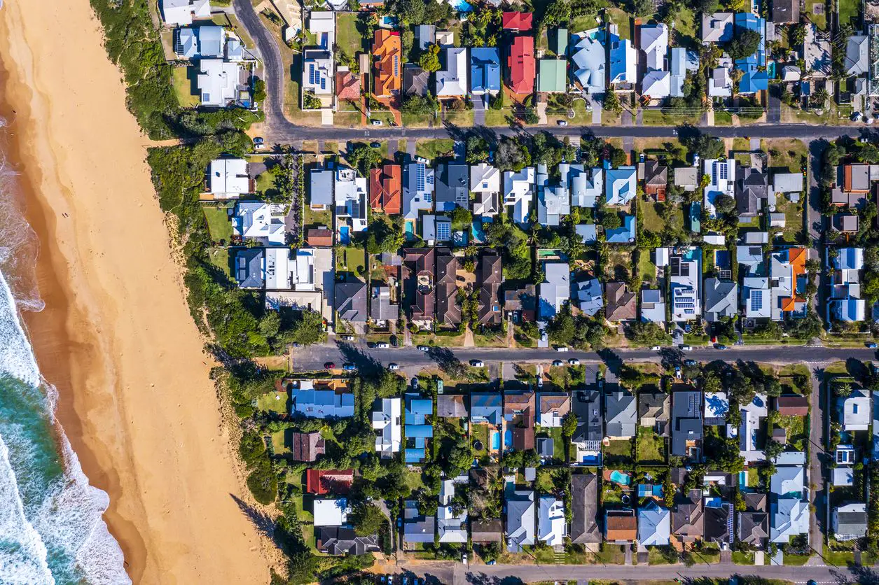 Aerial view of a coastal Australian suburb next to the beach
