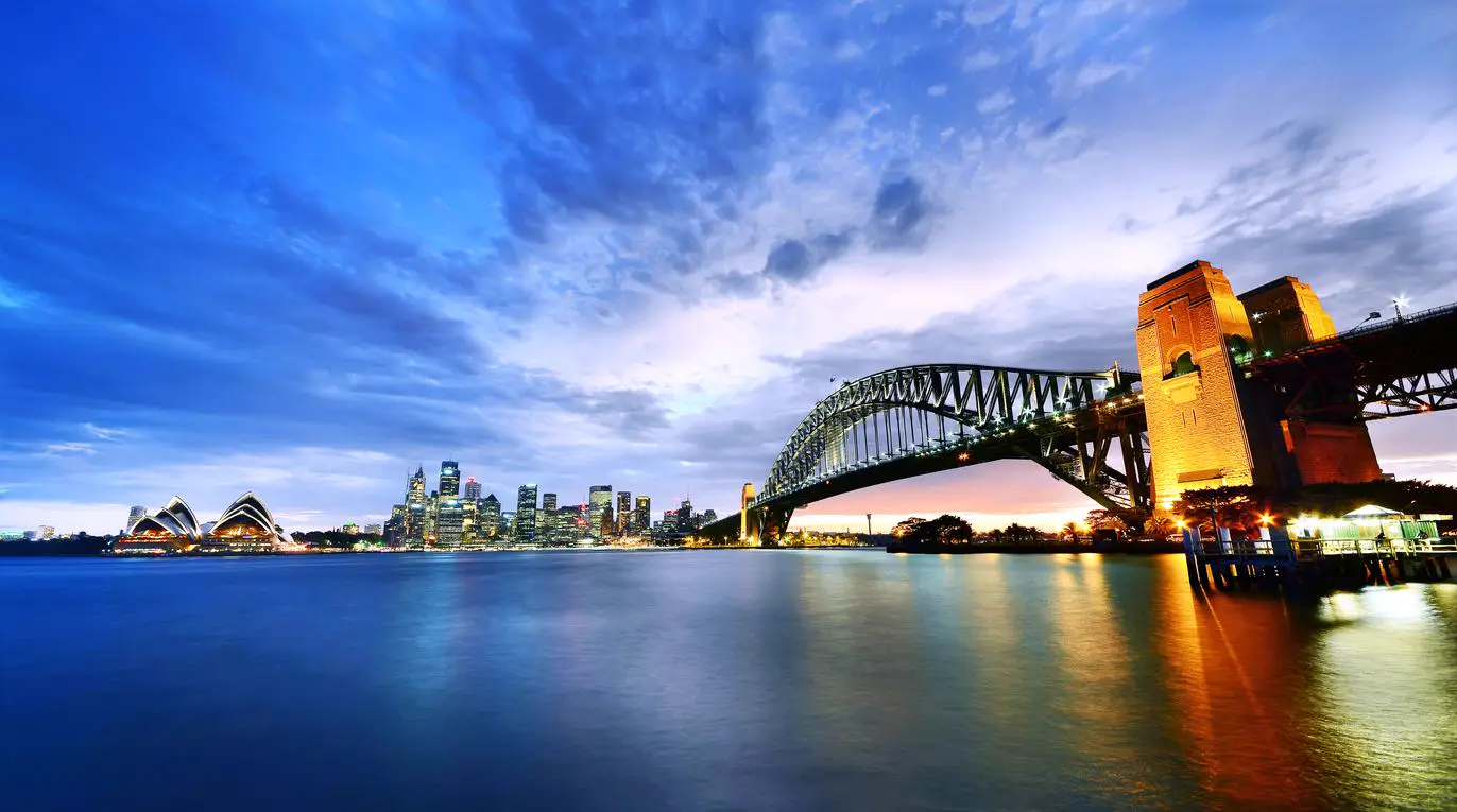 Sydney Harbour Bridge and city skyline at dusk
