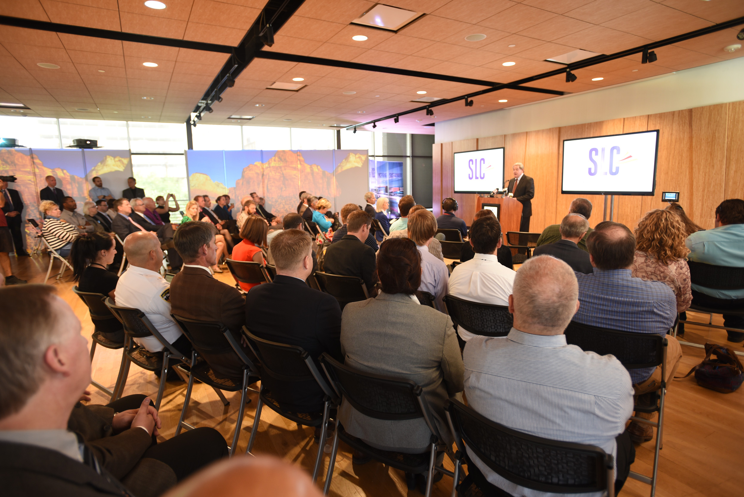 Man speaking to audience about SLC Airport