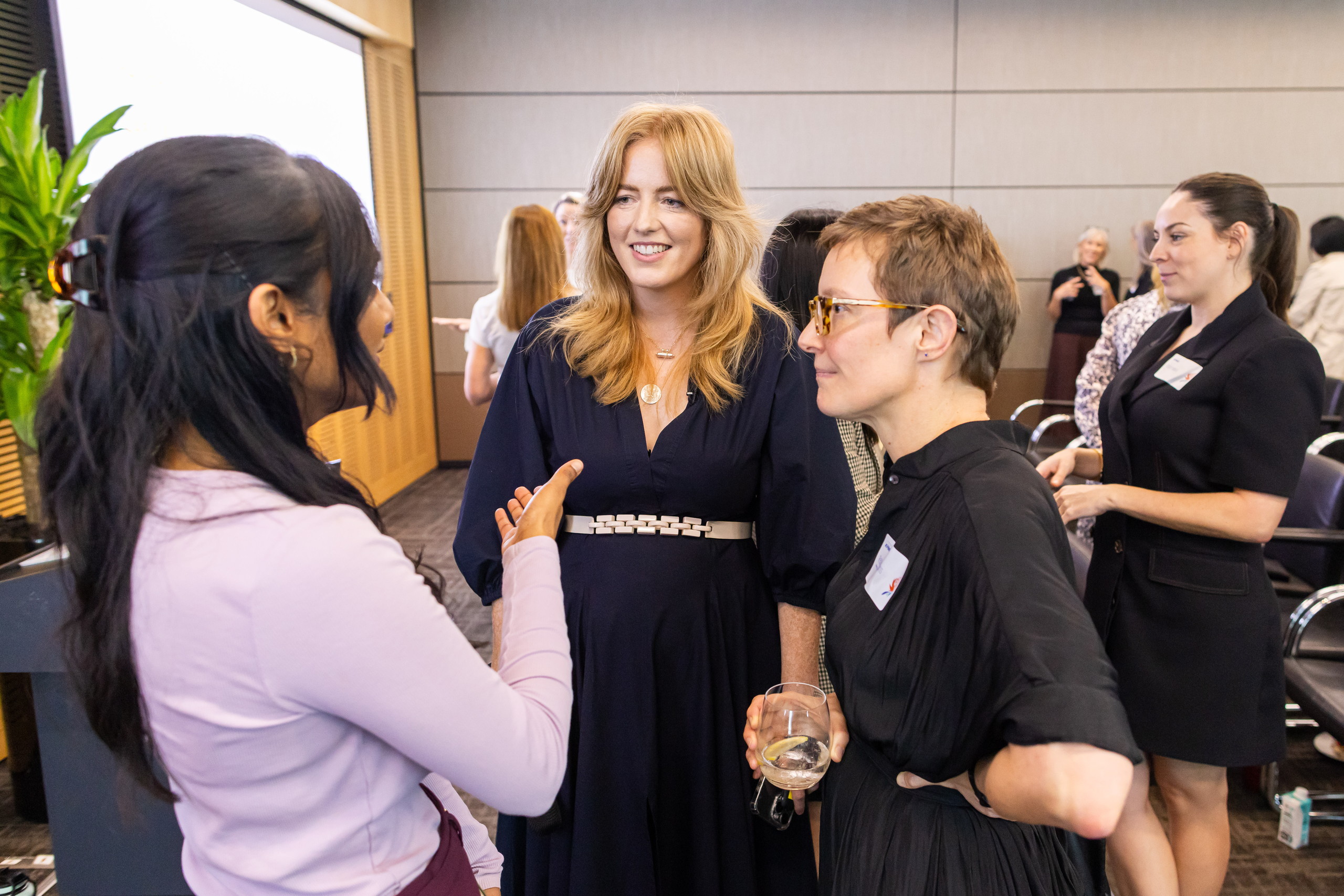 Guests talking with Arabella Macpherson over drinks at a Real Influence event