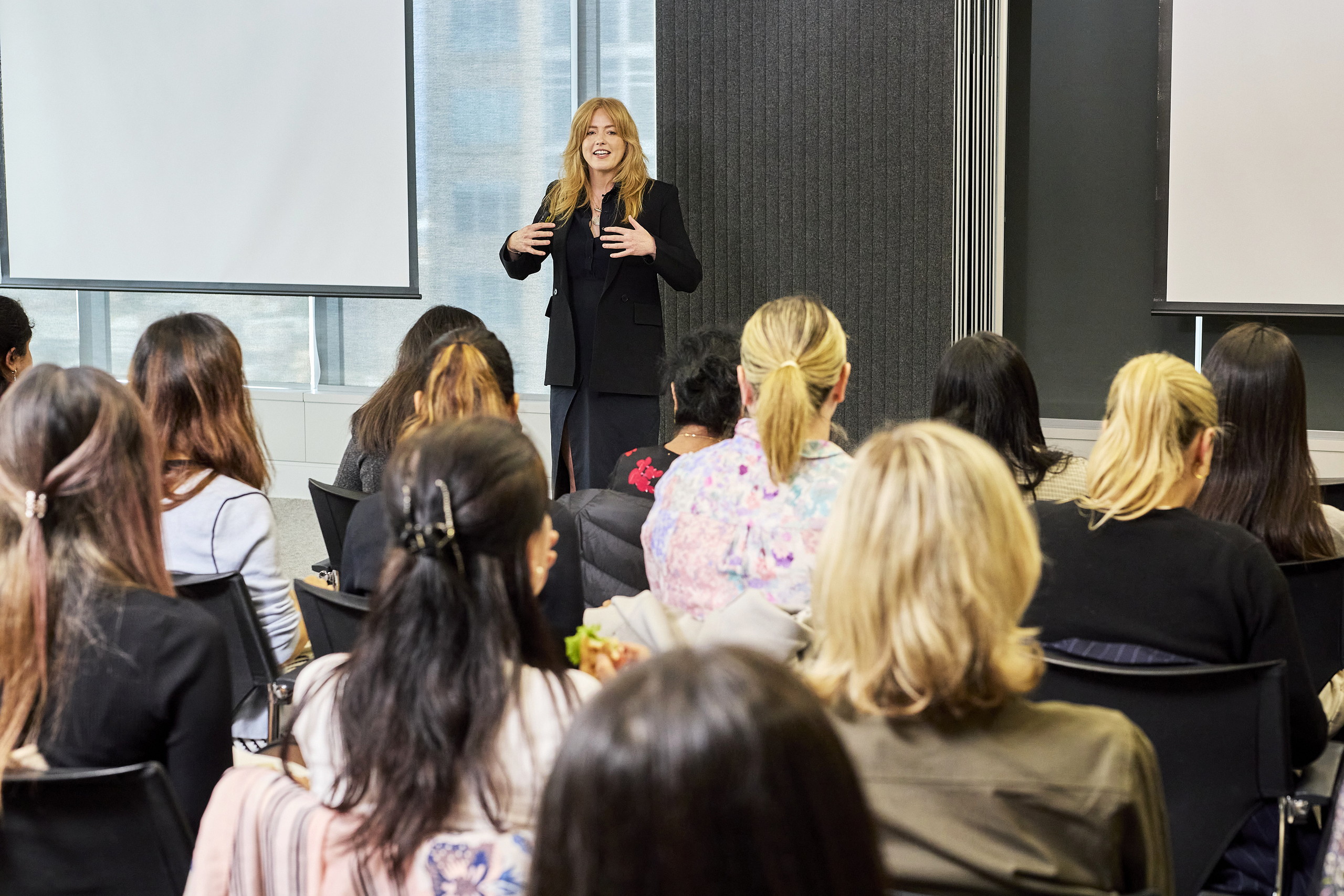 Arabella Macpherson leading a session with a seated group of leaders