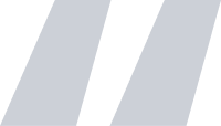 A graphic of a grey quote mark